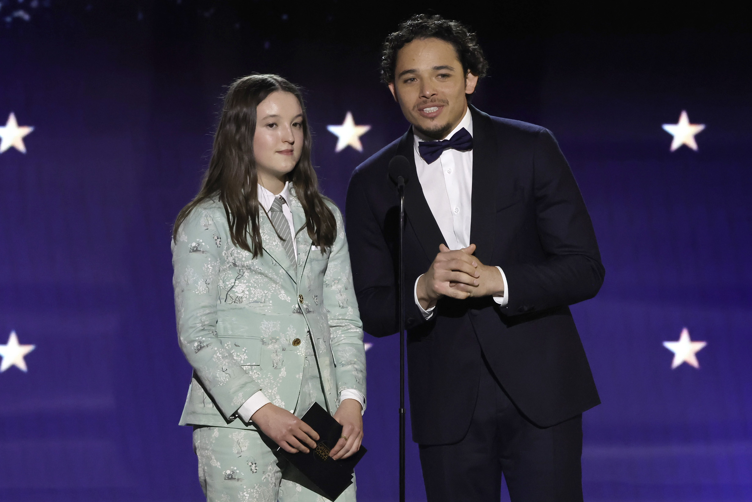 Bella Ramsey and Trevor Noah onstage at the 2024 Critics Choice Awards.