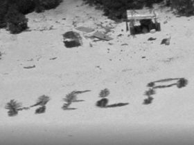 Stranded on island, men spell ‘HELP’ with palm fronds