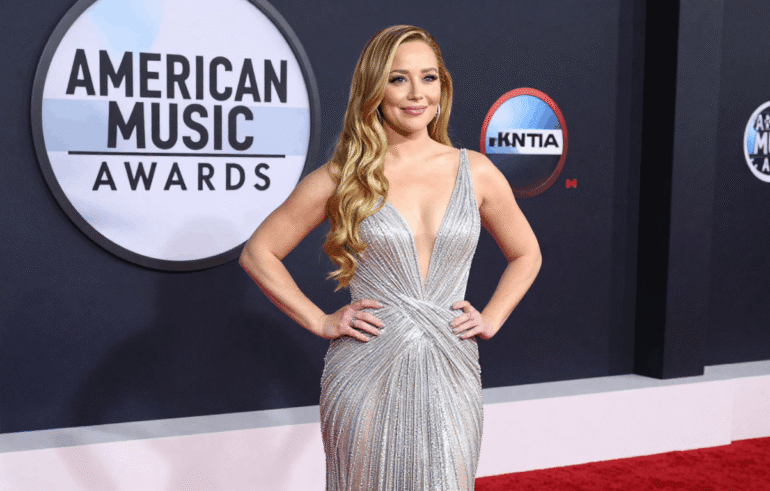 Hilary Duff wearing shimmering silver gown on the red carpet at the 2026 American Music Awards in Las Vegas